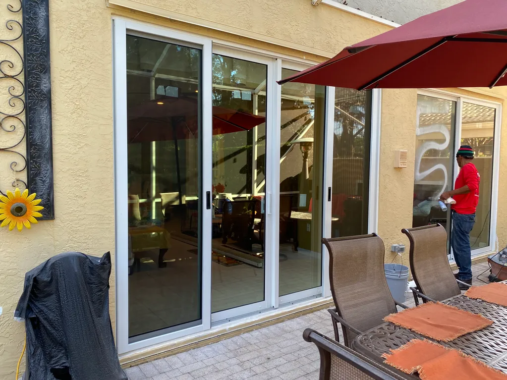 Sunshine Impact team installing impact sliding glass doors