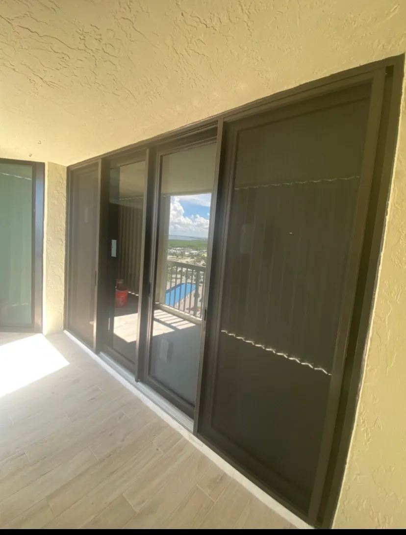 Impact sliding glass door installation — high-rise condo